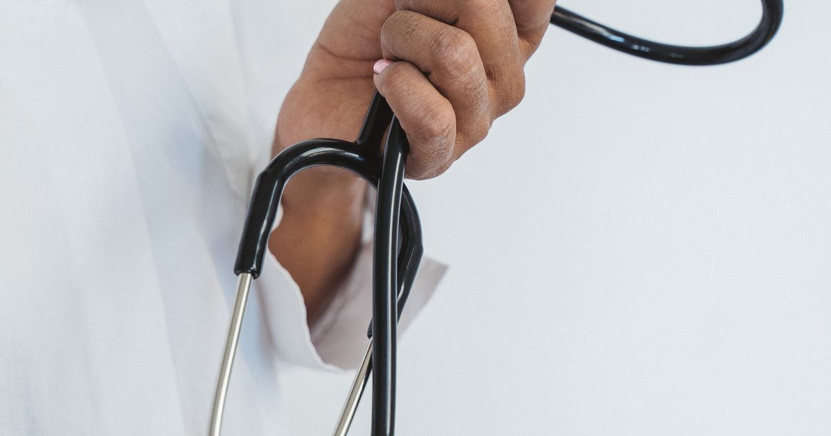 Close-up of a health worker's hands holding a stethoscope